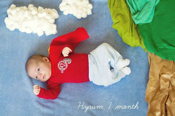 baby photoshoot idea as superman in clouds