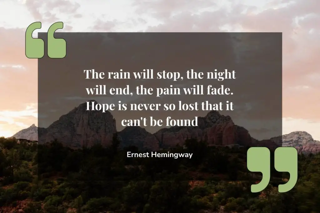 Ernest Hemingway quote on picture of mountains with sun rising from behind